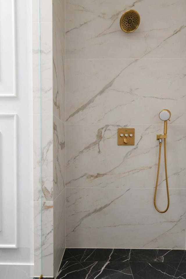 bathroom with a marble finish shower and marble finish floor