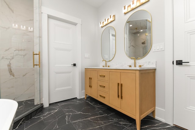 bathroom with a marble finish shower, marble finish floor, double vanity, and a sink