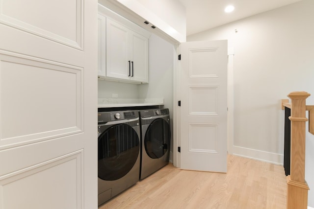 washroom with light wood-type flooring, recessed lighting, cabinet space, baseboards, and washing machine and clothes dryer