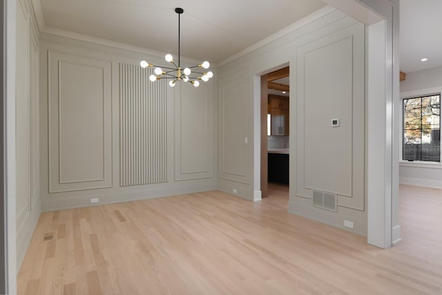 unfurnished dining area with a chandelier, a decorative wall, light wood-style flooring, and visible vents