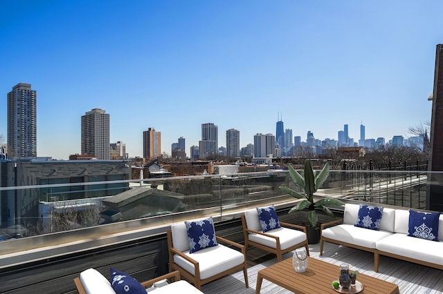 exterior space with outdoor lounge area, a balcony, and a view of city