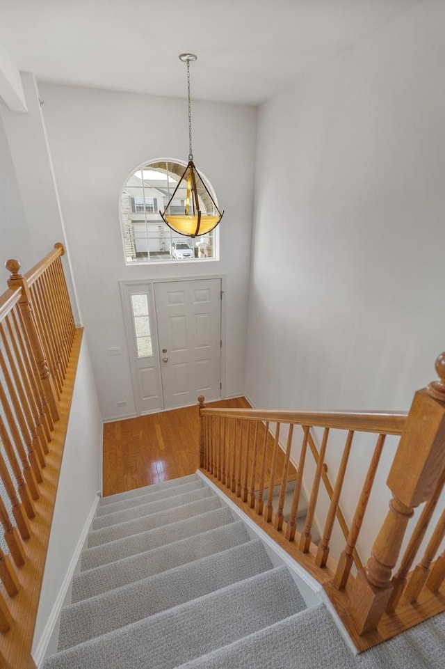 stairs featuring baseboards and wood finished floors