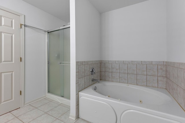 full bathroom featuring tile patterned floors, a jetted tub, and a stall shower