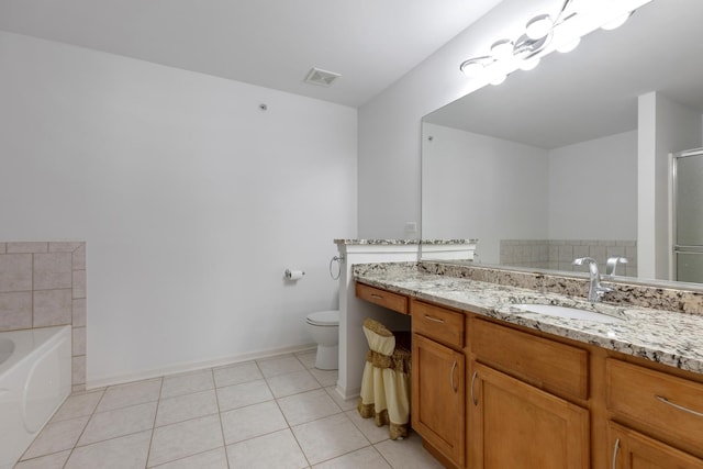 full bath featuring tile patterned flooring, visible vents, toilet, a garden tub, and vanity