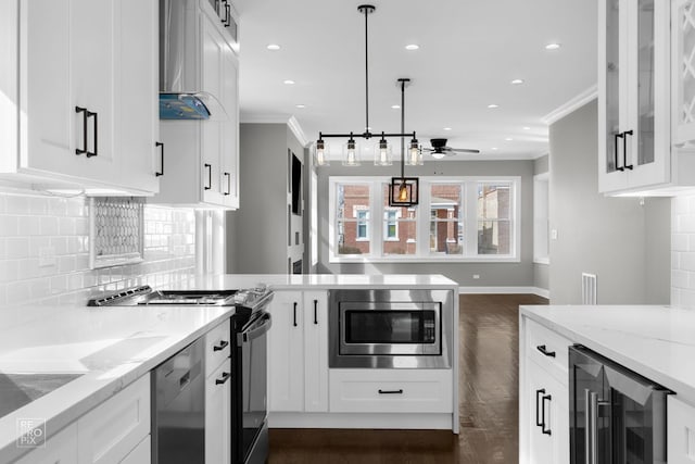 kitchen with wall chimney range hood, wine cooler, ornamental molding, appliances with stainless steel finishes, and a peninsula