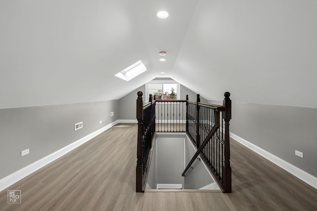 bonus room featuring visible vents, baseboards, and wood finished floors