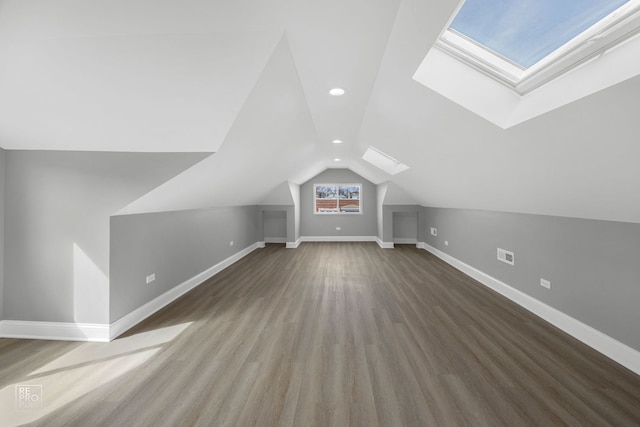 bonus room featuring recessed lighting, baseboards, wood finished floors, and vaulted ceiling with skylight