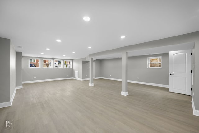 below grade area featuring baseboards and wood finished floors