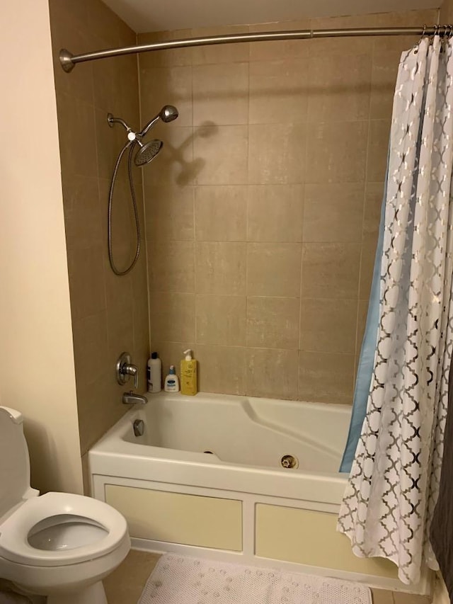 full bath featuring tile patterned floors, toilet, and shower / bath combo