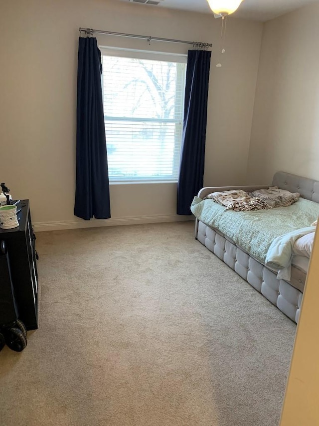 bedroom featuring visible vents, baseboards, and carpet