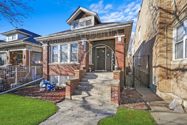 view of front of property with brick siding and fence