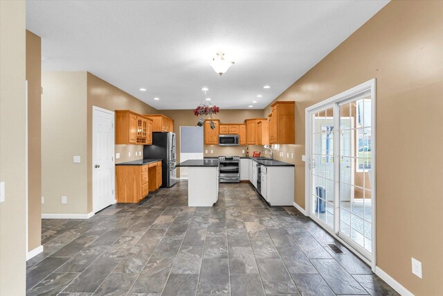 3402 Mill Creek Ct, Champaign, IL 61822 - kitchen featuring a healthy amount of sunlight, appliances with stainless steel finishes, baseboards, and dark countertops