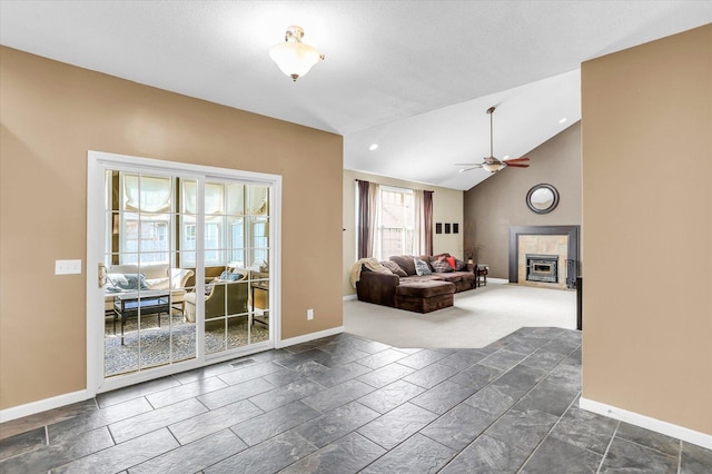 3402 Mill Creek Ct, Champaign, IL 61822 - living room with ceiling fan, stone tile floors, baseboards, a tile fireplace, and vaulted ceiling