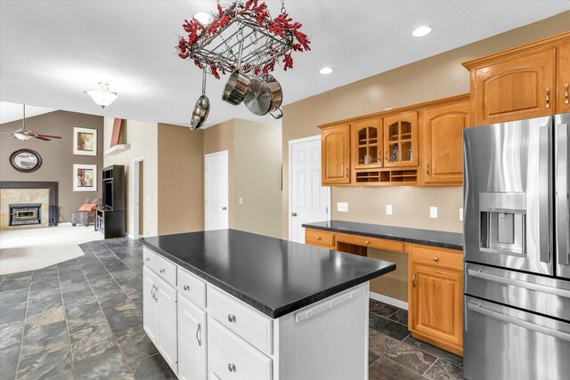 3402 Mill Creek Ct, Champaign, IL 61822 - kitchen featuring ceiling fan, dark countertops, a center island, stainless steel fridge with ice dispenser, and stone tile floors