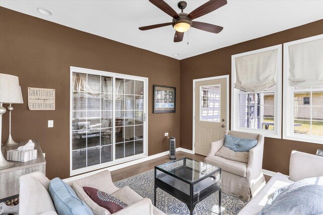 3402 Mill Creek Ct, Champaign, IL 61822 - living area with baseboards, ceiling fan, wood finished floors, and a wealth of natural light