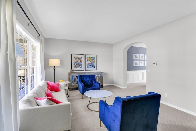 3402 Mill Creek Ct, Champaign, IL 61822 - carpeted living room featuring a healthy amount of sunlight, arched walkways, and baseboards