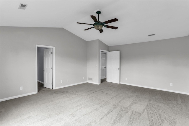 3402 Mill Creek Ct, Champaign, IL 61822 - empty room featuring visible vents, baseboards, dark carpet, ceiling fan, and vaulted ceiling