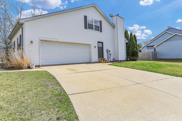3402 Mill Creek Ct, Champaign, IL 61822 - view of side of property with fence, a garage, a chimney, a lawn, and driveway