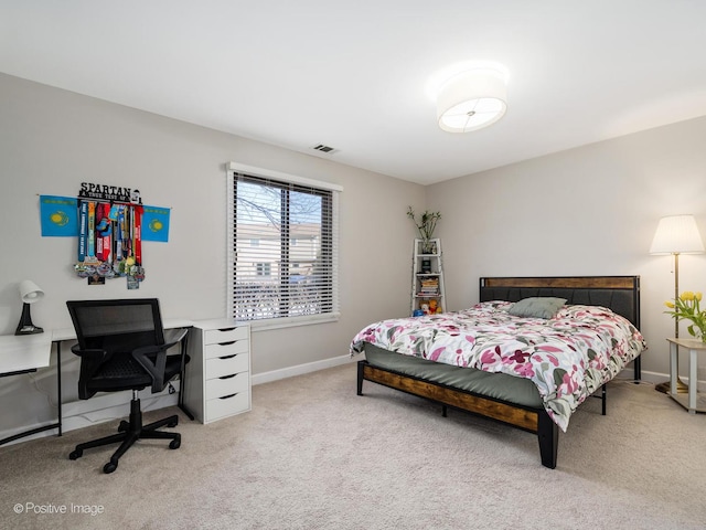 carpeted bedroom featuring visible vents and baseboards