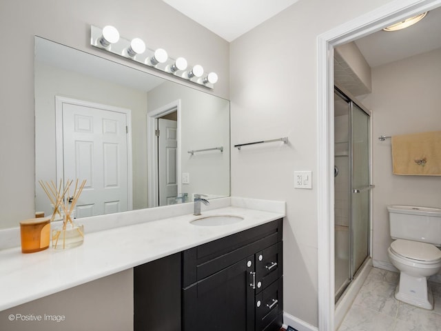 bathroom featuring vanity, toilet, marble finish floor, and a stall shower