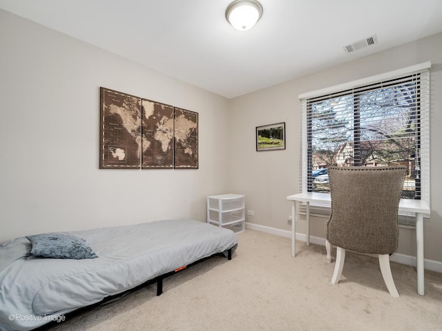 bedroom featuring visible vents, baseboards, and light carpet