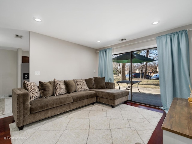 living room featuring light wood-style flooring, recessed lighting, and visible vents