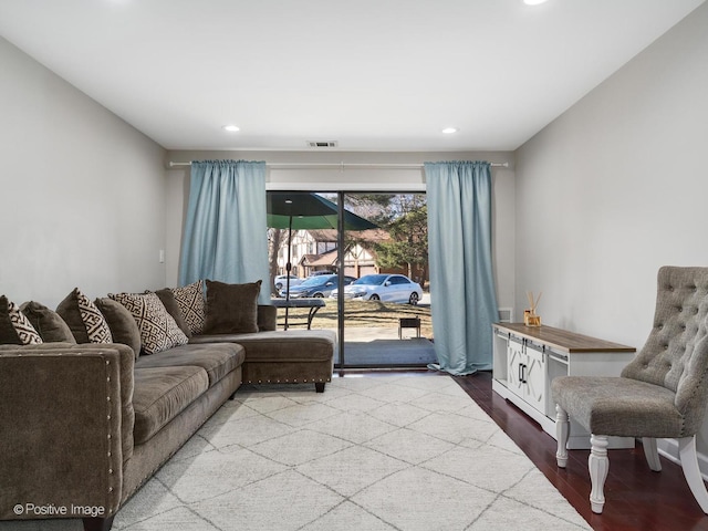 living area featuring recessed lighting, visible vents, and wood finished floors