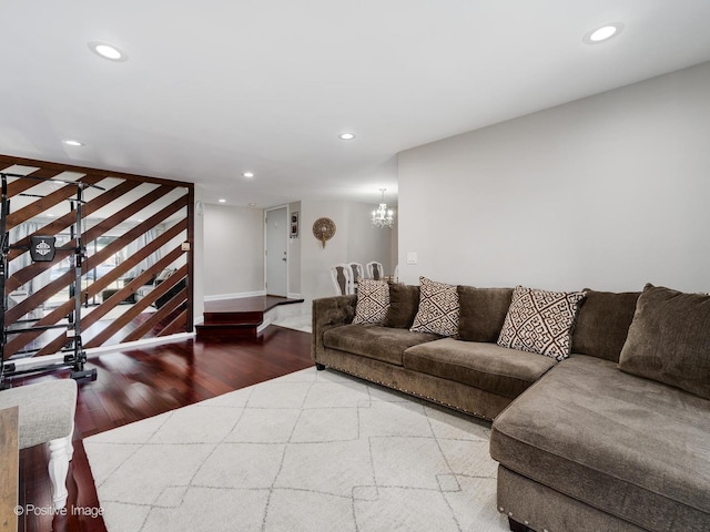 living area with an inviting chandelier, recessed lighting, wood finished floors, and baseboards