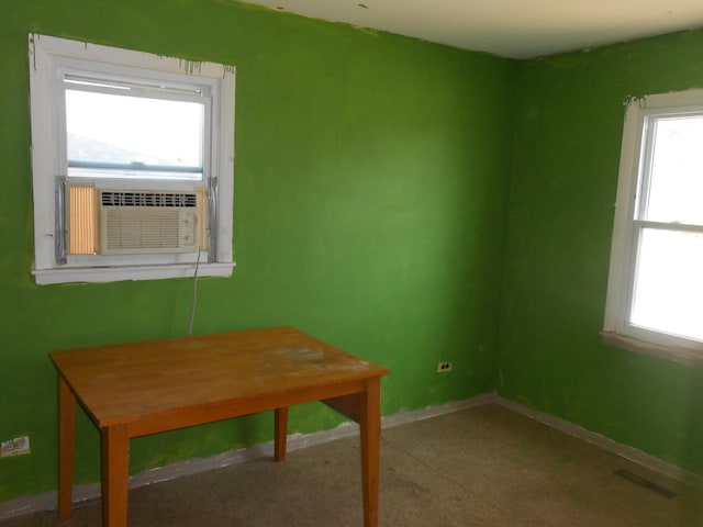 interior space featuring visible vents, cooling unit, and baseboards