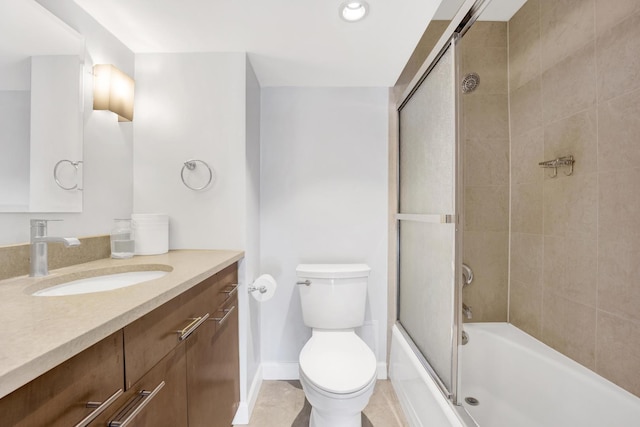 bathroom with combined bath / shower with glass door, baseboards, toilet, and vanity