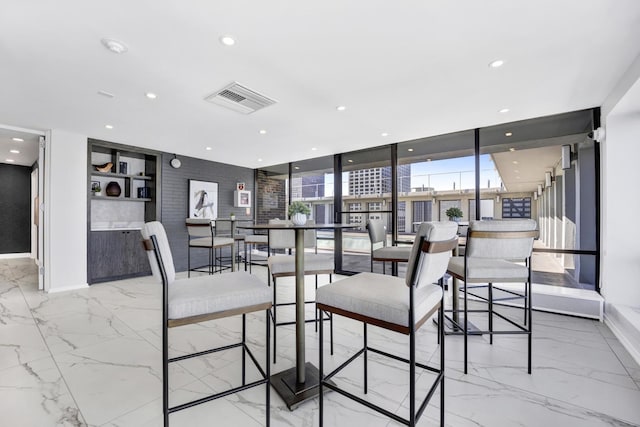 dining room with visible vents, recessed lighting, marble finish floor, and baseboards