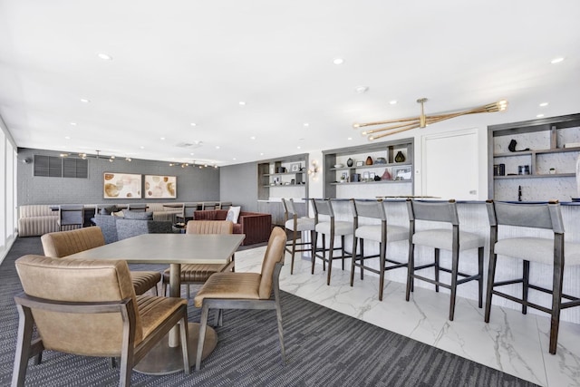 dining space featuring recessed lighting and marble finish floor