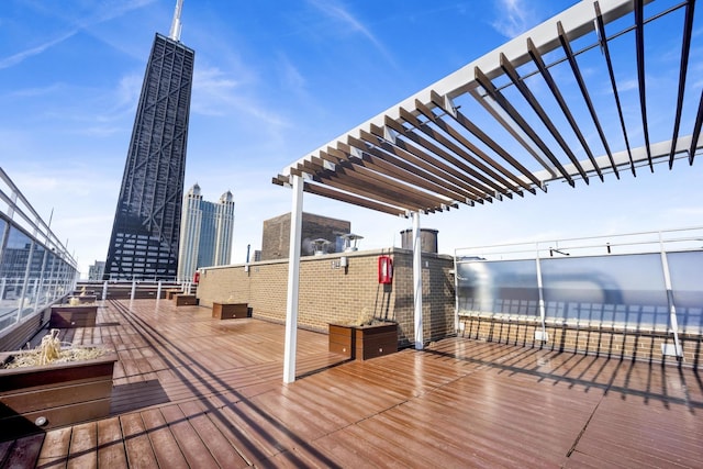 deck featuring a view of city, a pergola, and a water view