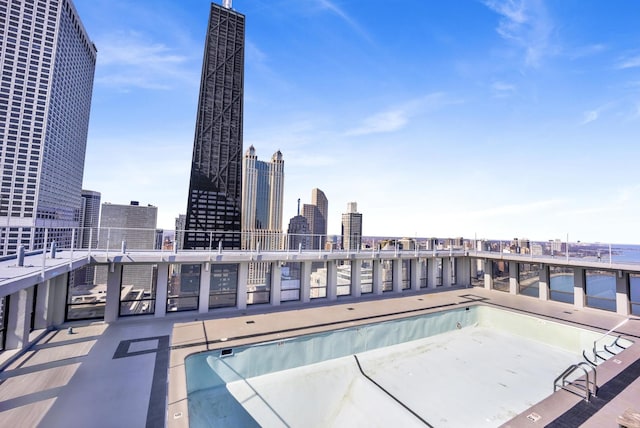 pool featuring a patio area and a view of city