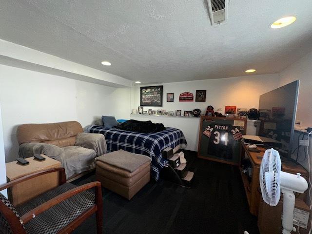 bedroom with visible vents, recessed lighting, and a textured ceiling