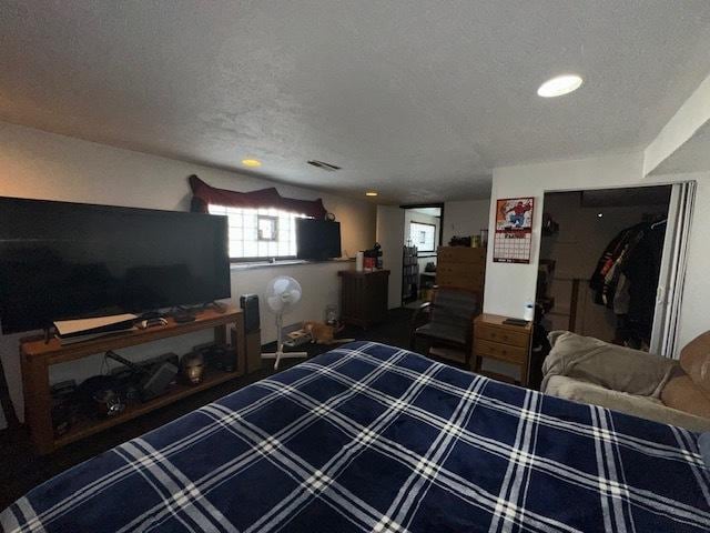 bedroom featuring visible vents and a textured ceiling