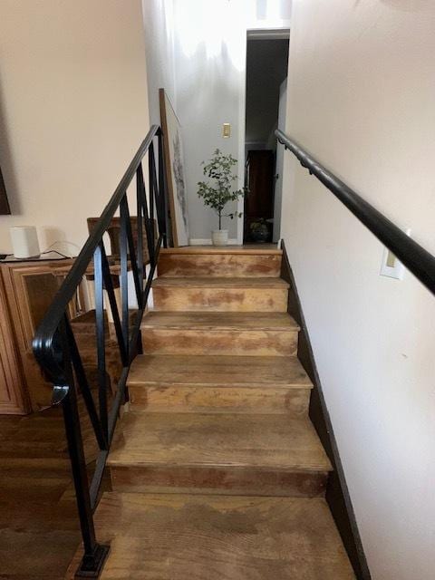 stairway with wood finished floors