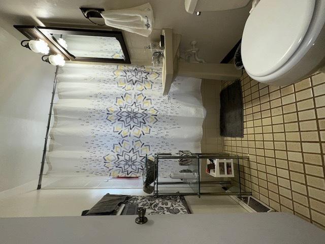 bathroom featuring visible vents and toilet