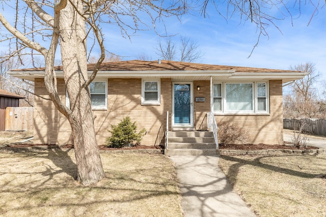 view of front of property featuring brick siding and fence