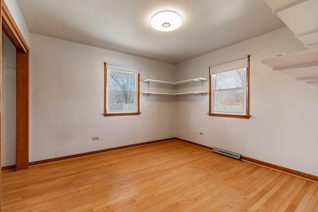 unfurnished bedroom featuring light wood finished floors, visible vents, a closet, and baseboards