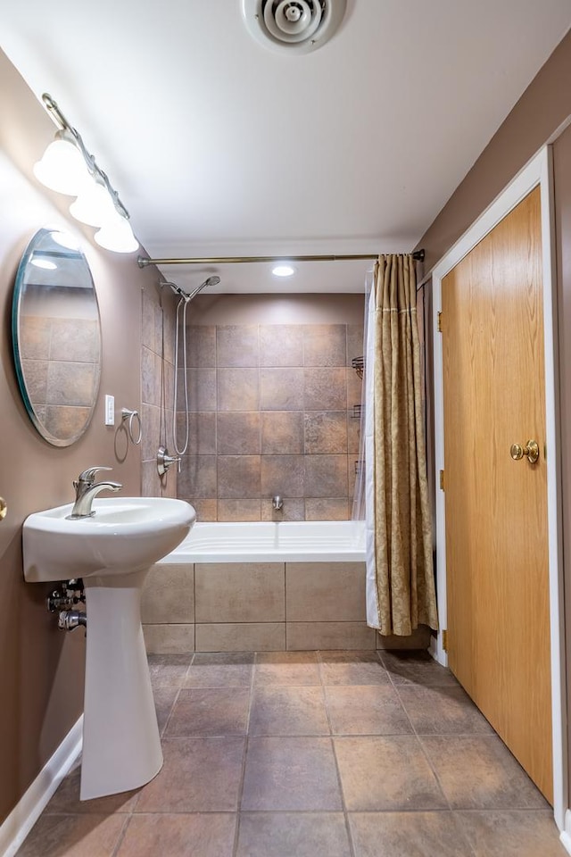 bathroom featuring visible vents and tiled shower / bath combo