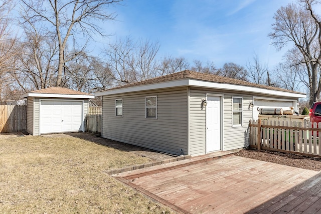 view of outbuilding featuring an outbuilding and fence