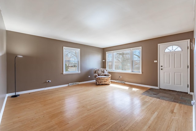 entryway featuring visible vents, light wood-type flooring, and baseboards