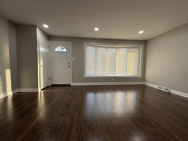 foyer entrance featuring recessed lighting, visible vents, baseboards, and dark wood-style floors