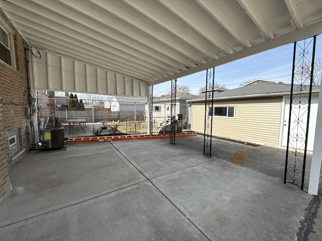 view of patio featuring central air condition unit and fence