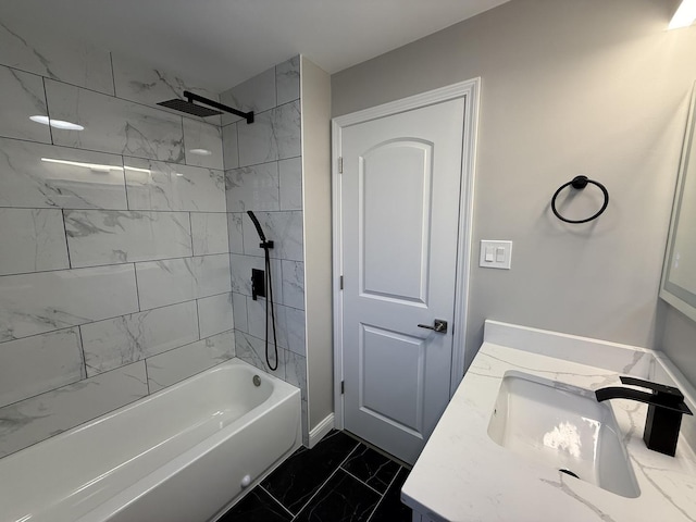 full bathroom featuring washtub / shower combination, marble finish floor, and vanity