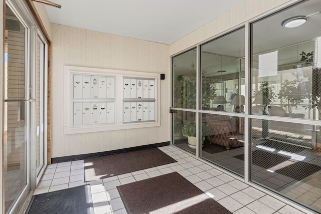 unfurnished sunroom with mail area