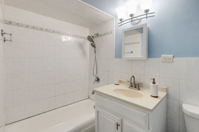 full bath with toilet, tile walls, bathtub / shower combination, and vanity