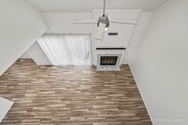 unfurnished living room with wood finished floors and a fireplace