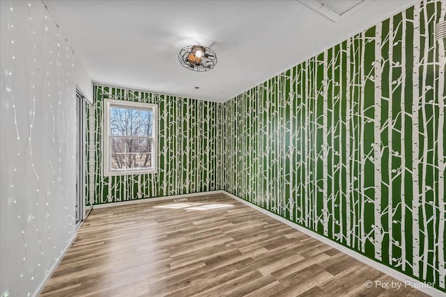 empty room with wood finished floors and baseboards